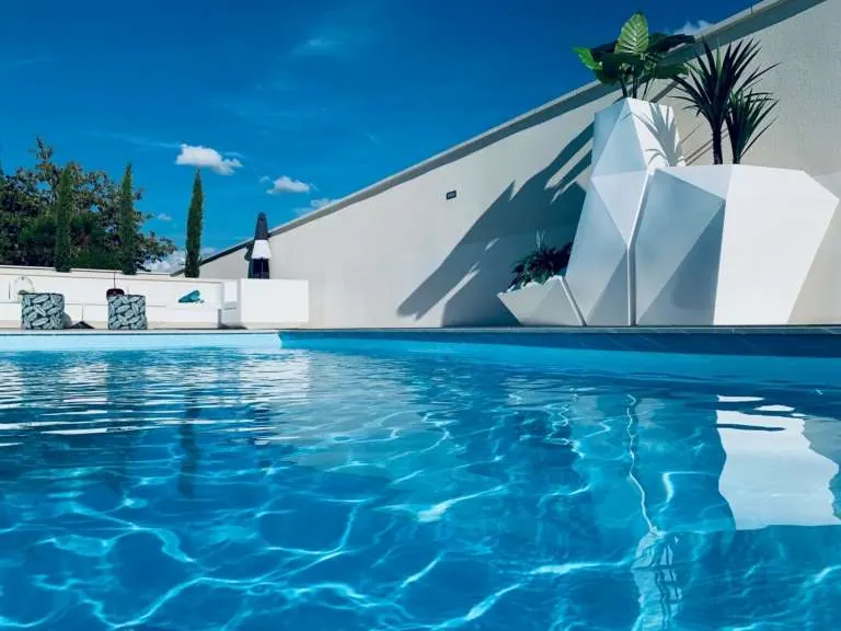 Piscine design avec eau bleue et jardinières